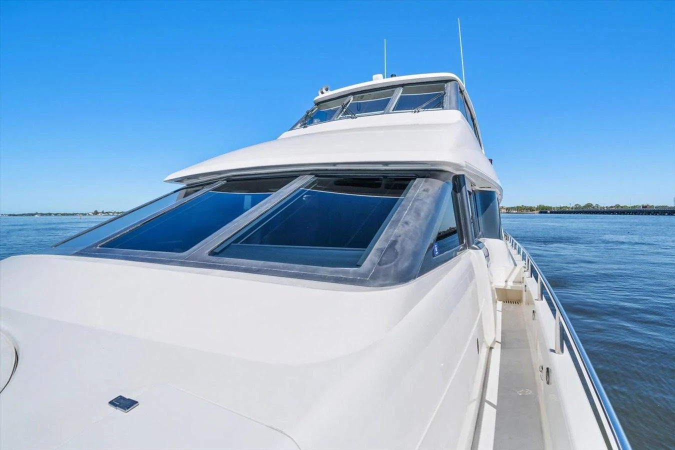 A sleek yacht cruising on calm waters under a clear blue sky. aboard OCTOPI Yacht for Sale