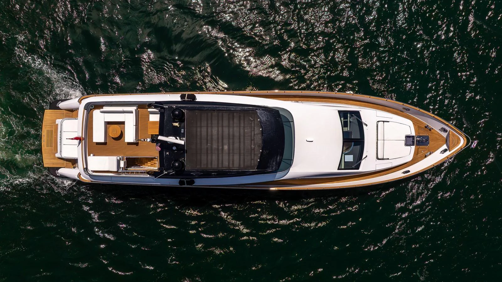 A sleek yacht glides through the water, showcasing its elegant design from an aerial perspective. aboard SEA METRI V Yacht for Sale