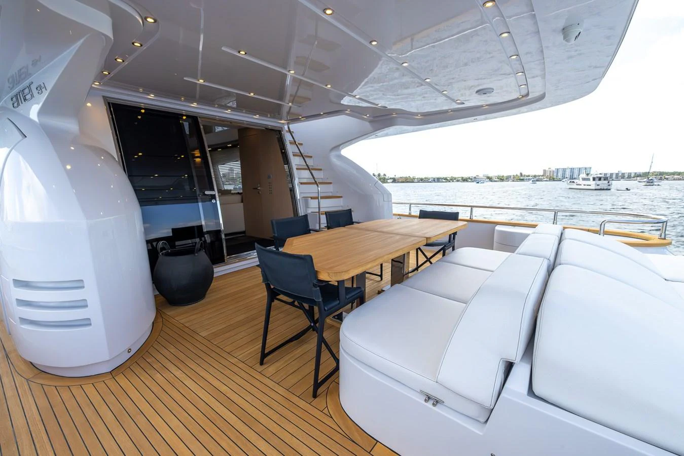 The aft deck features a spacious seating area with a dining table, perfect for alfresco dining and relaxation. aboard SEA METRI V Yacht for Sale