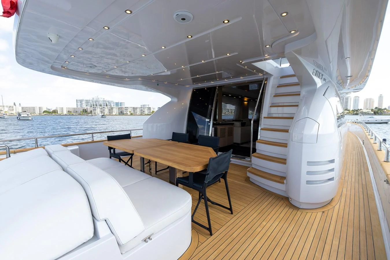 The aft deck features a spacious seating area with a dining table, perfect for alfresco meals and relaxation. aboard SEA METRI V Yacht for Sale