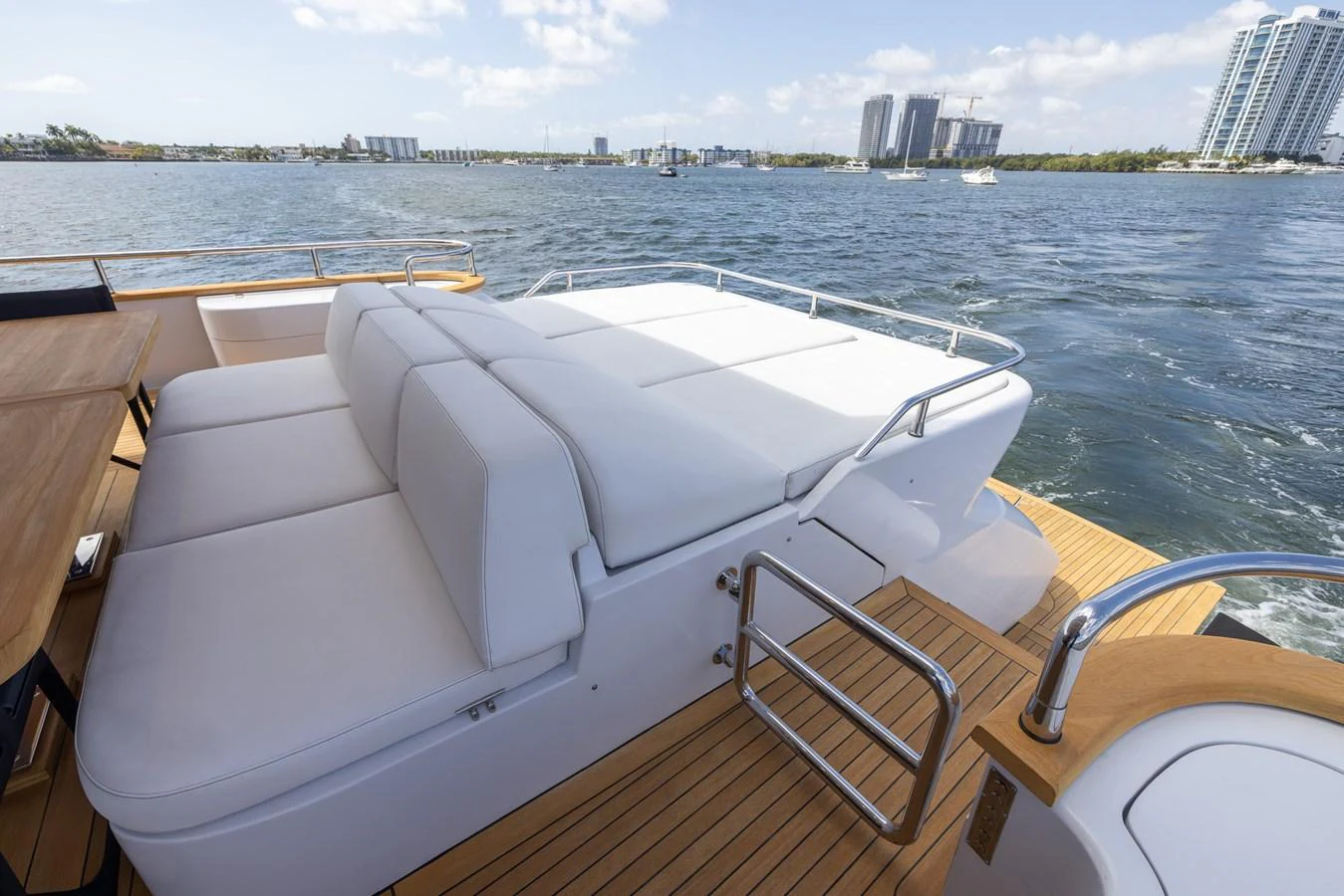 The sundeck features luxurious white loungers with a stunning waterfront view. aboard SEA METRI V Yacht for Sale