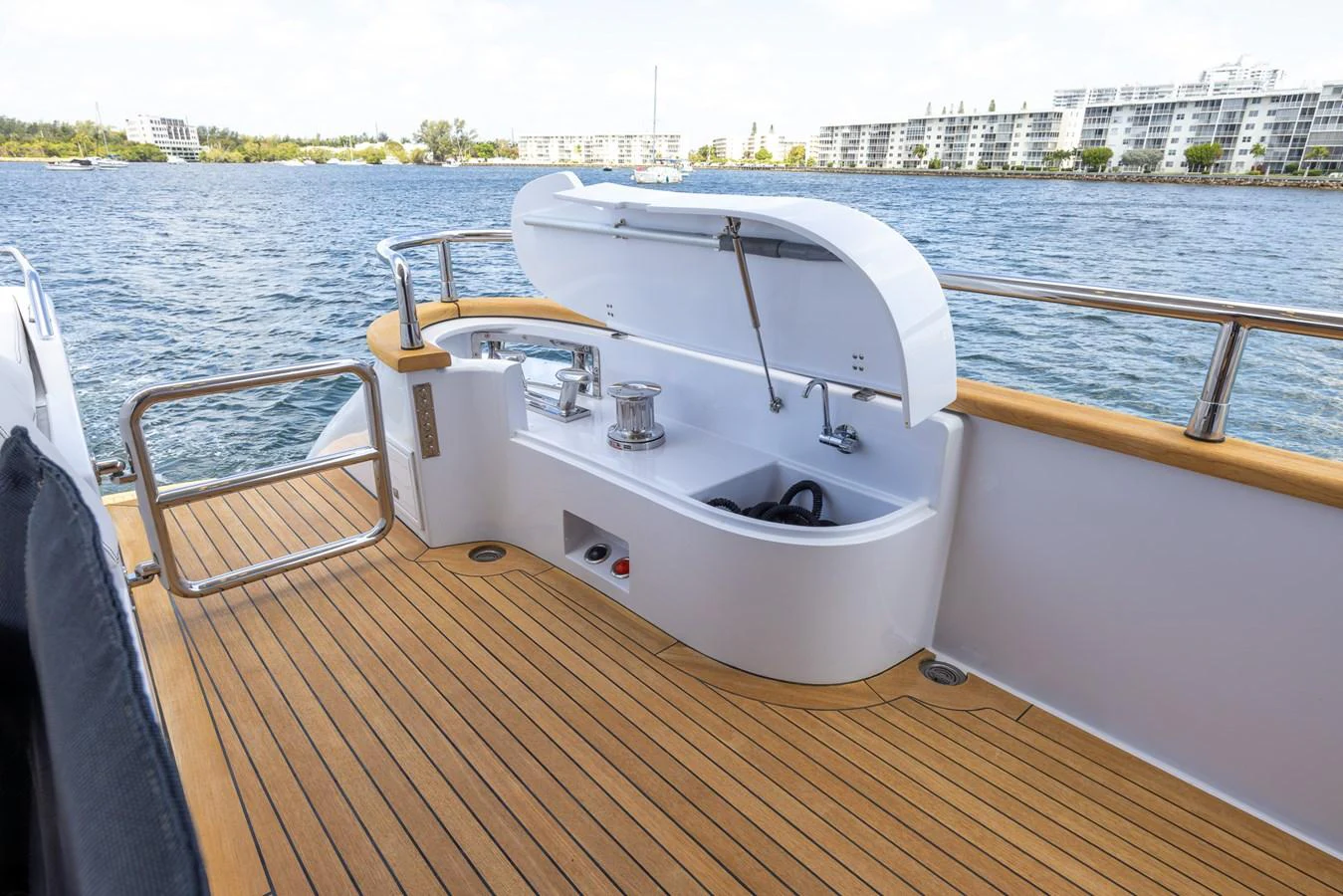 The aft deck features a clean and functional layout with a storage compartment and winches. aboard SEA METRI V Yacht for Sale
