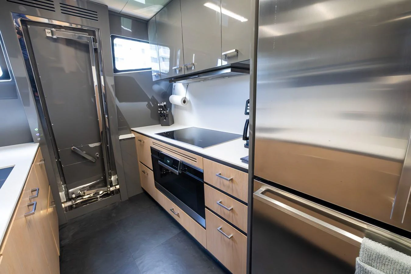 The yacht's galley is equipped with modern appliances and sleek cabinetry, offering a functional and stylish space for meal preparation. aboard SEA METRI V Yacht for Sale
