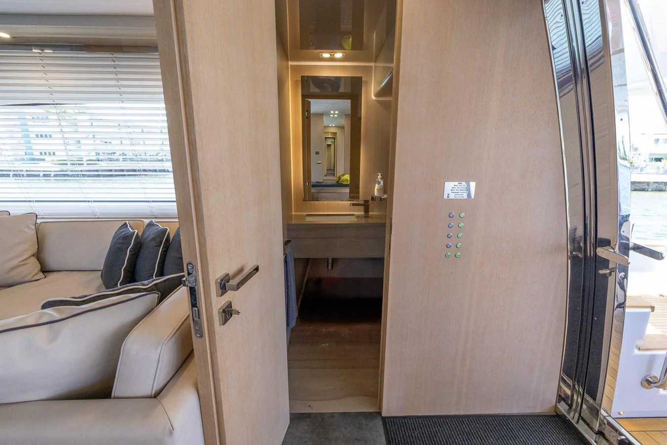 The image showcases a modern interior space with a view into a cozy room featuring a couch and a small desk area. aboard SEA METRI V Yacht for Sale