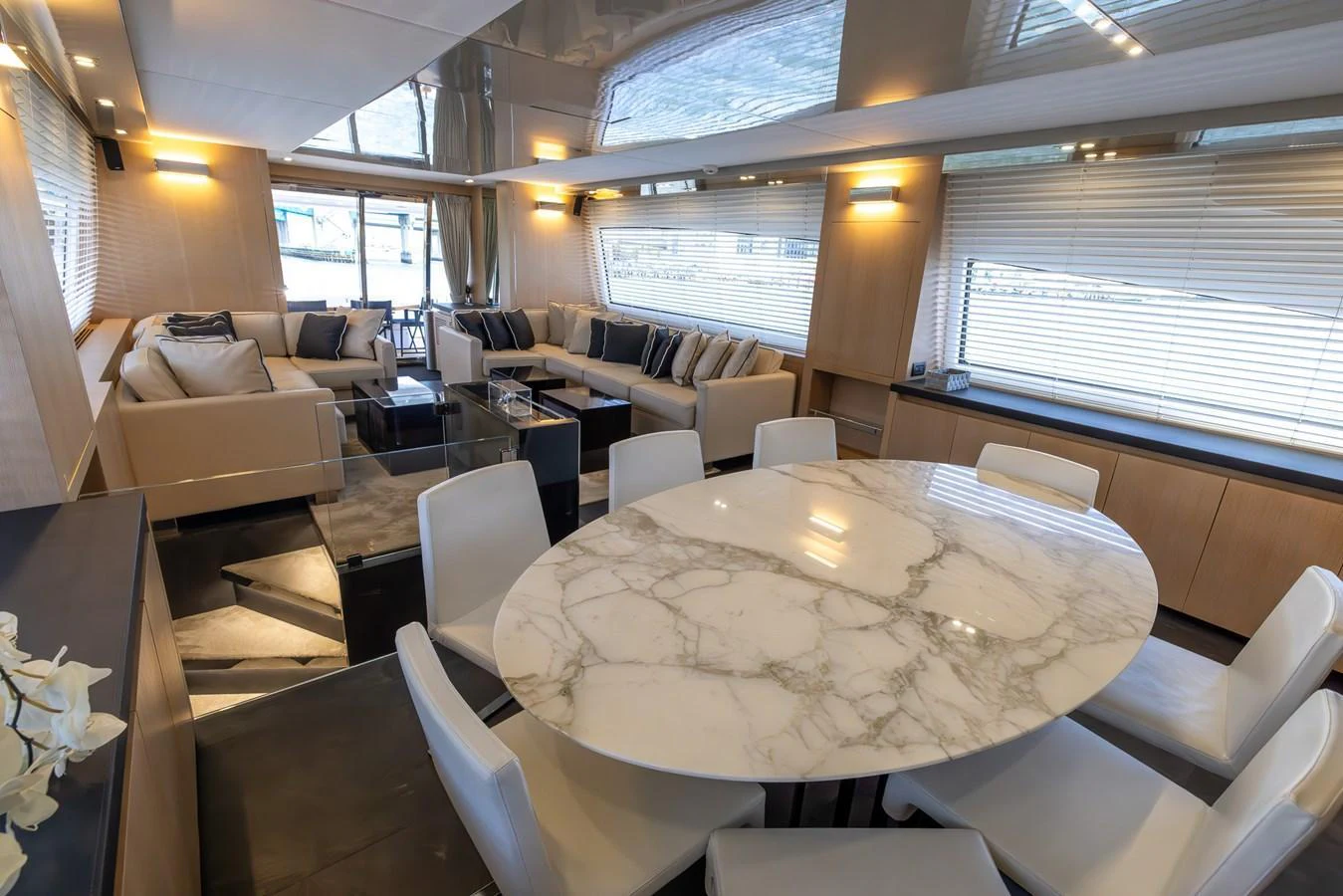 The yacht's salon features a luxurious seating area and a stylish dining table with a marble top. aboard SEA METRI V Yacht for Sale