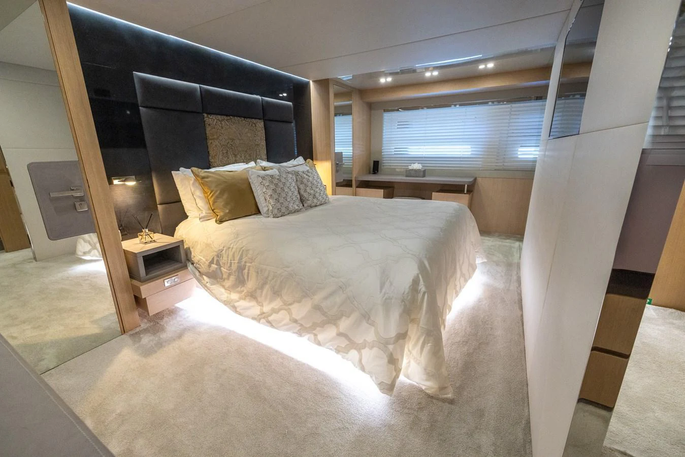 The master stateroom features a luxurious bed with modern lighting and elegant decor. aboard SEA METRI V Yacht for Sale
