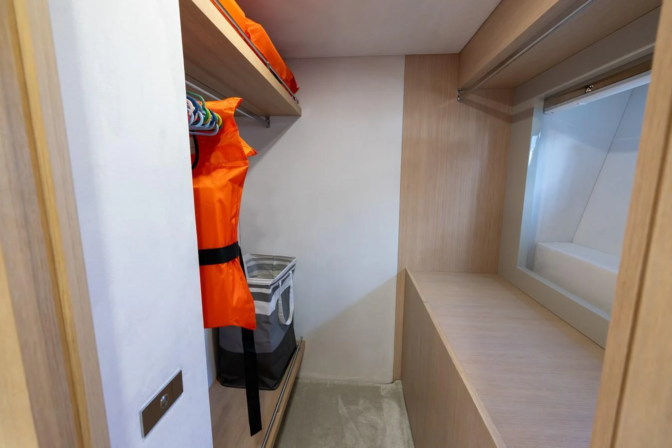 A neatly organized storage area with life jackets and shelves. aboard SEA METRI V Yacht for Sale