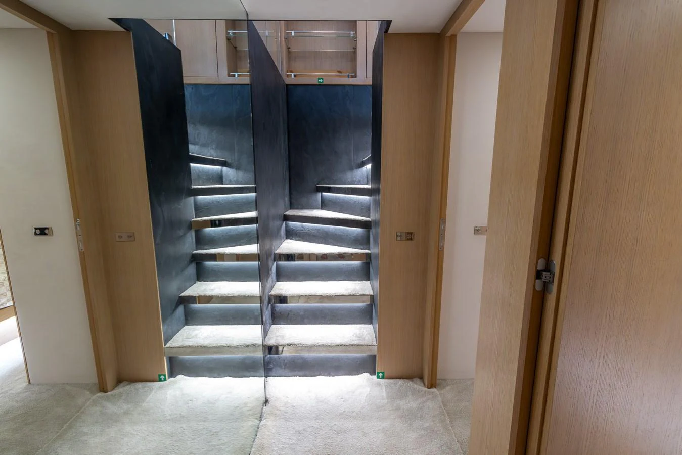 A modern staircase with sleek design elements and ambient lighting. aboard SEA METRI V Yacht for Sale