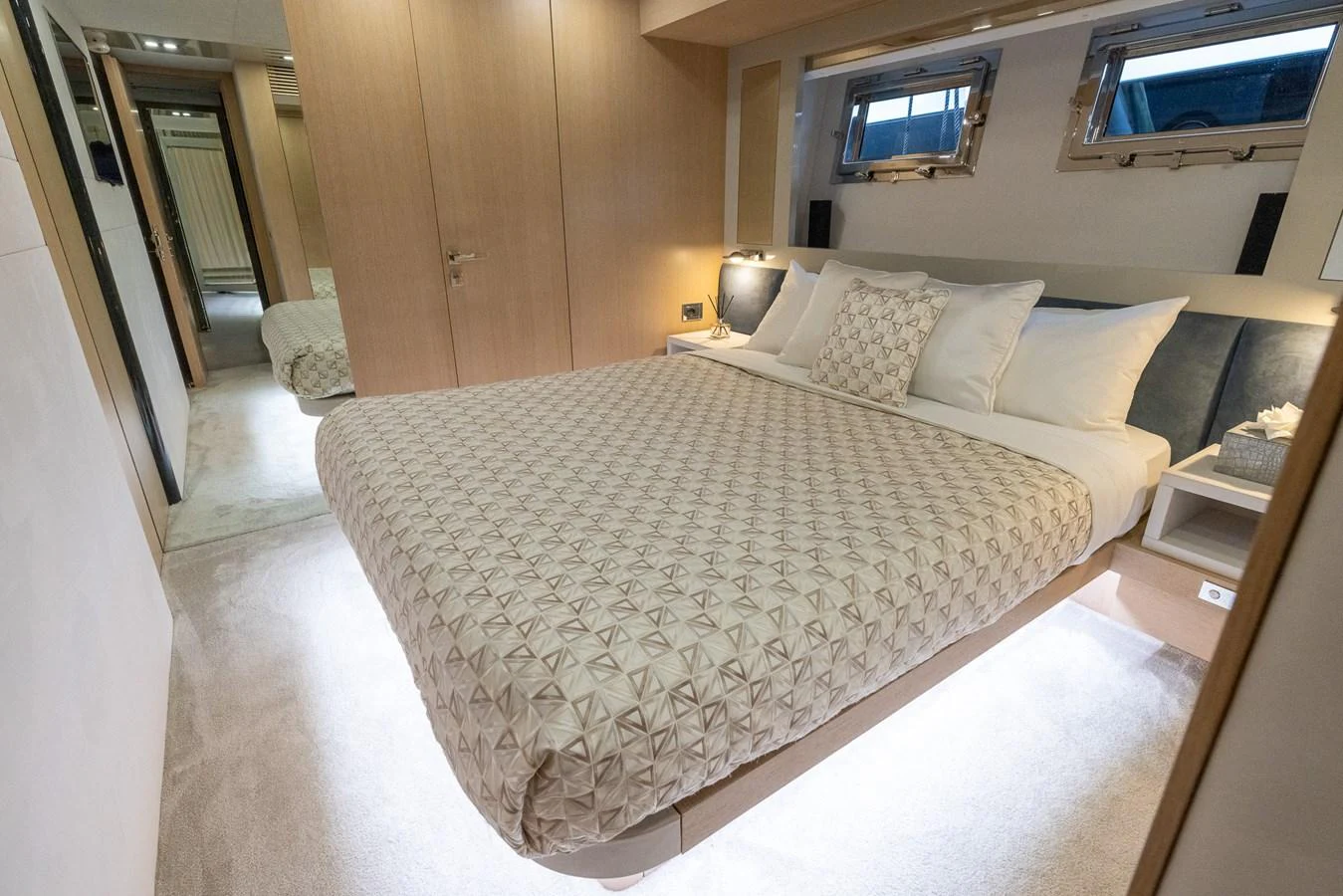 The stateroom features a spacious bed with elegant bedding and modern lighting. aboard SEA METRI V Yacht for Sale