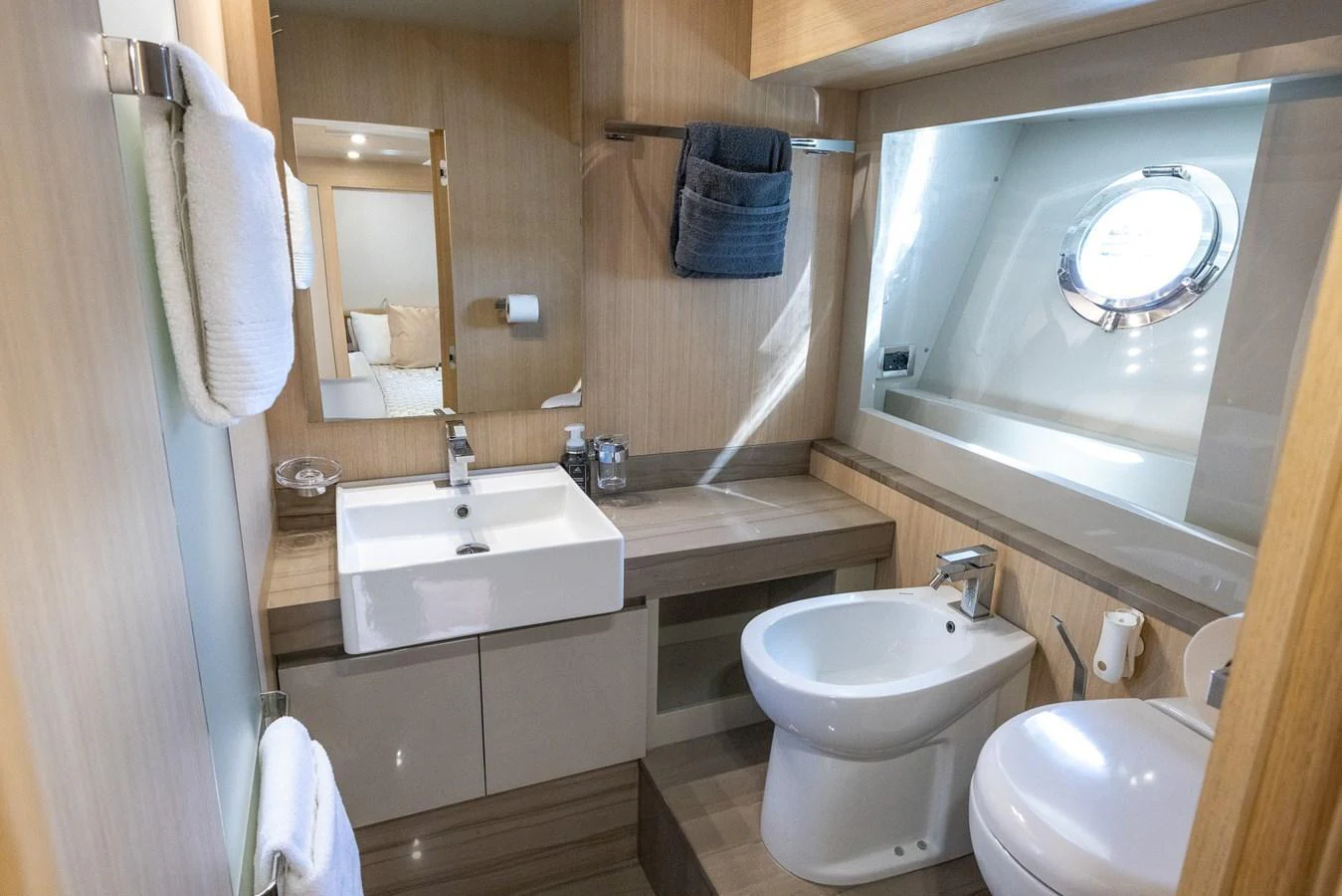 A modern yacht bathroom with sleek fixtures and a porthole window. aboard SEA METRI V Yacht for Sale