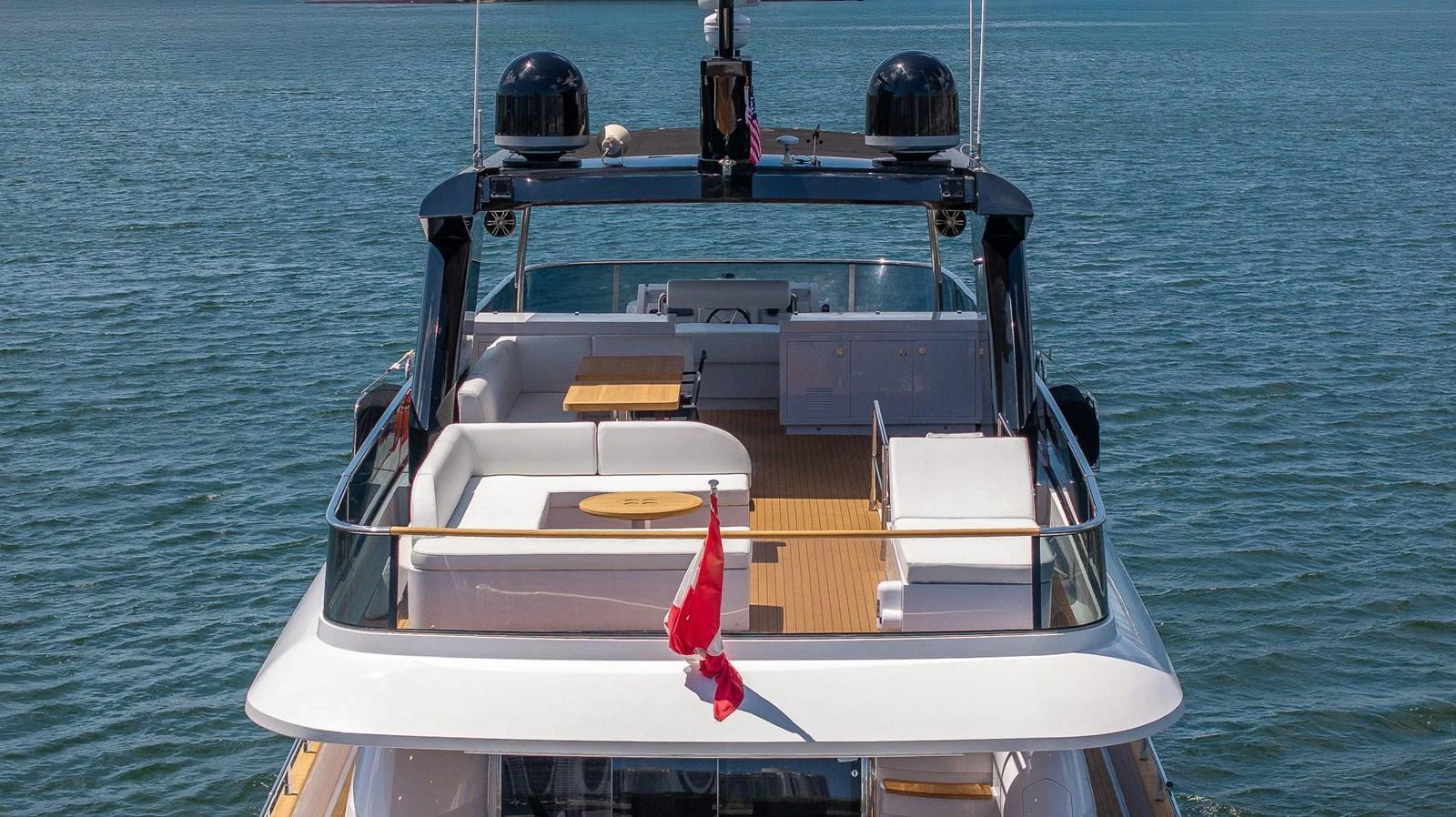The yacht's aft deck features a spacious seating area with a table, perfect for outdoor relaxation and dining. aboard SEA METRI V Yacht for Sale