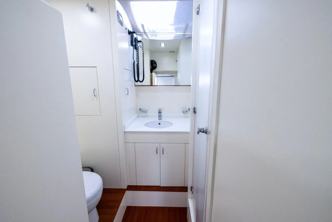 The yacht's head features a clean and modern design with a compact sink and ample storage. aboard SEA METRI V Yacht for Sale
