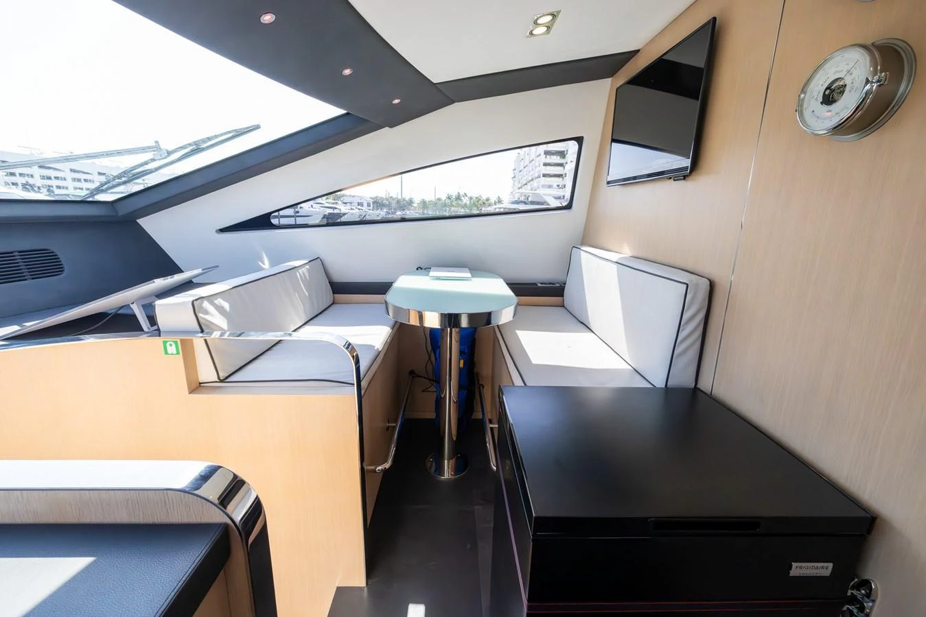 The salon features a modern seating area with a sleek table and ample natural light. aboard SEA METRI V Yacht for Sale