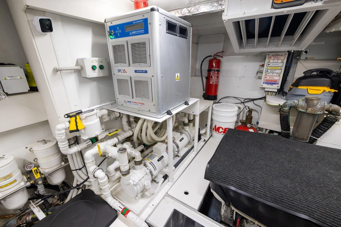 The image showcases the well-organized engine room with various mechanical components and safety equipment. aboard SEA METRI V Yacht for Sale