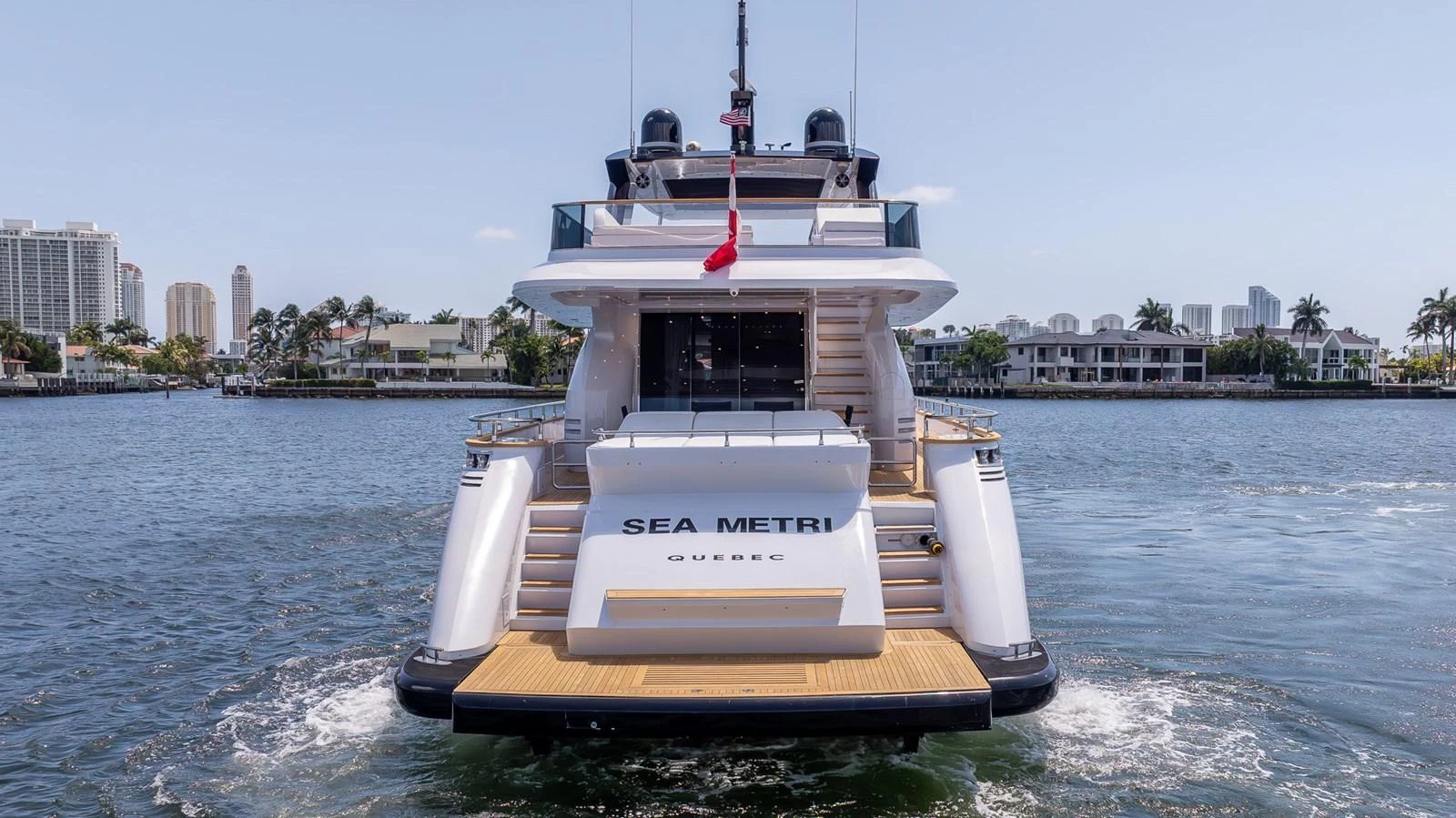 The yacht's aft deck is showcased with a view of the inviting swim platform and elegant design. aboard SEA METRI V Yacht for Sale
