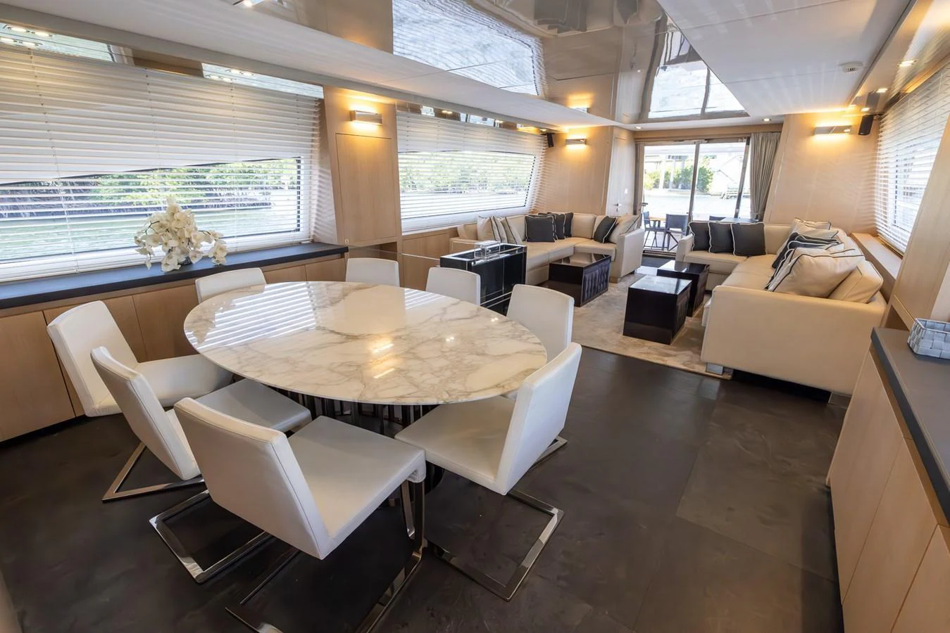 The yacht's salon features a luxurious dining area with a marble table and comfortable seating, complemented by a spacious lounge area with plush sofas. aboard SEA METRI V Yacht for Sale