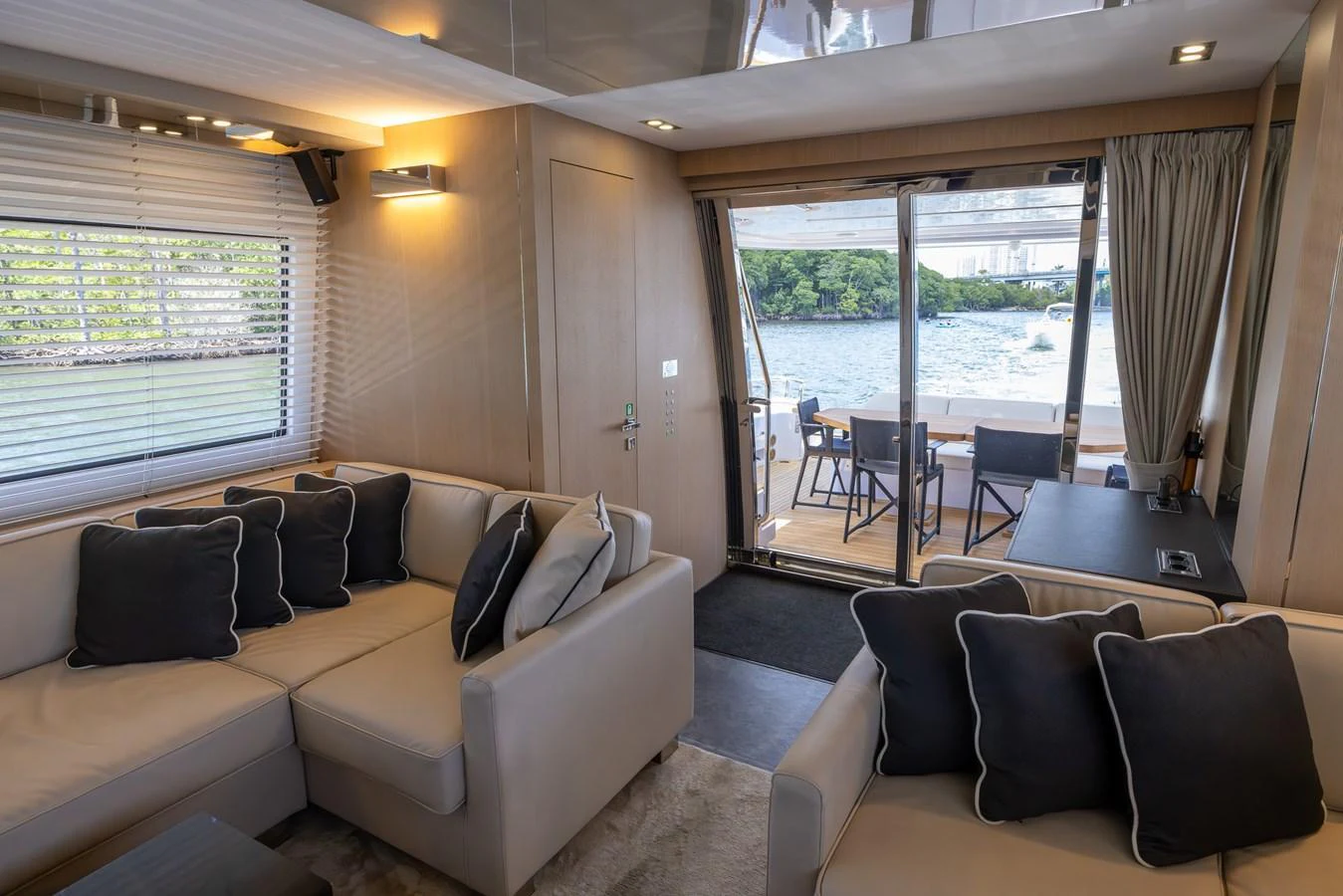 The yacht's salon offers a cozy seating area with a view of the aft deck and water beyond. aboard SEA METRI V Yacht for Sale