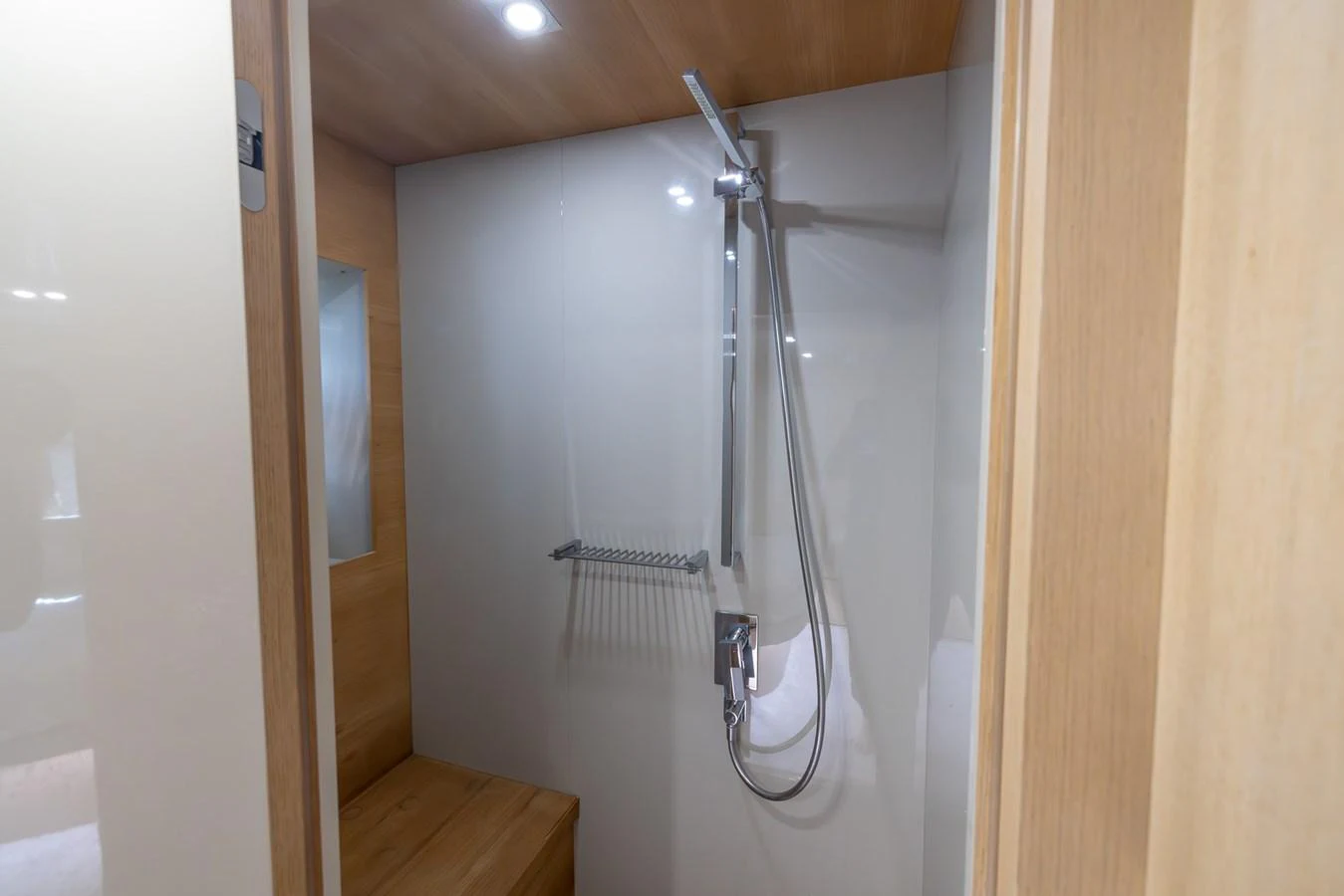 A sleek and modern shower area with wooden accents and a minimalist design. aboard SEA METRI V Yacht for Sale