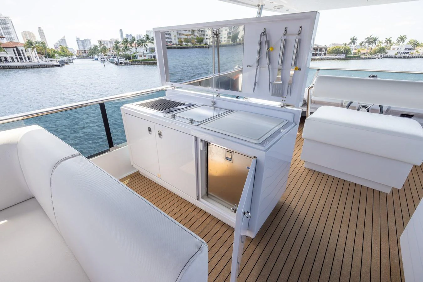 The yacht features a sleek outdoor galley with modern appliances and ample seating, perfect for alfresco dining. aboard SEA METRI V Yacht for Sale
