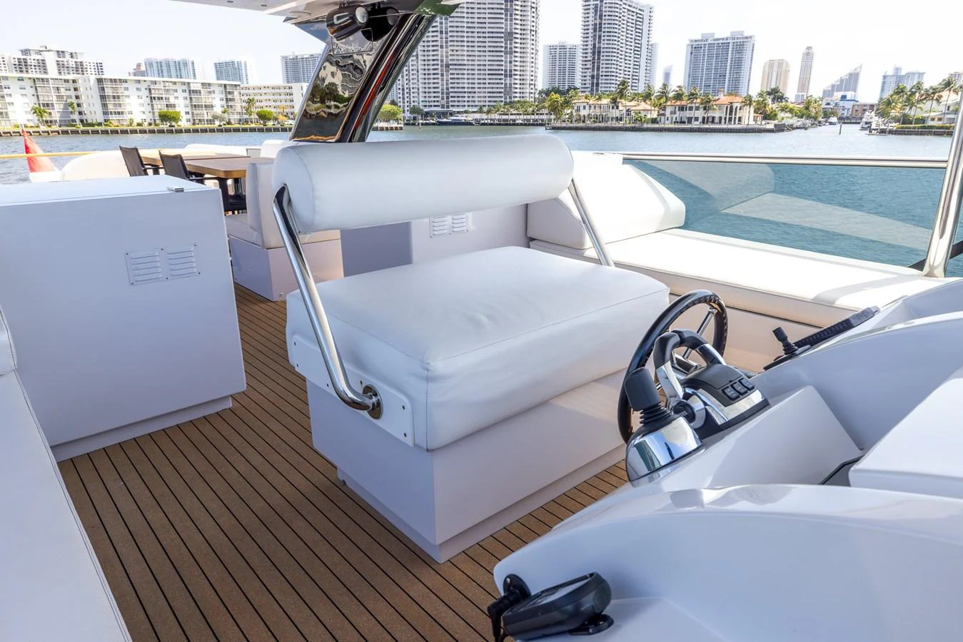 The helm area features a comfortable seating arrangement with a modern control console, offering a luxurious and functional space for navigation. aboard SEA METRI V Yacht for Sale