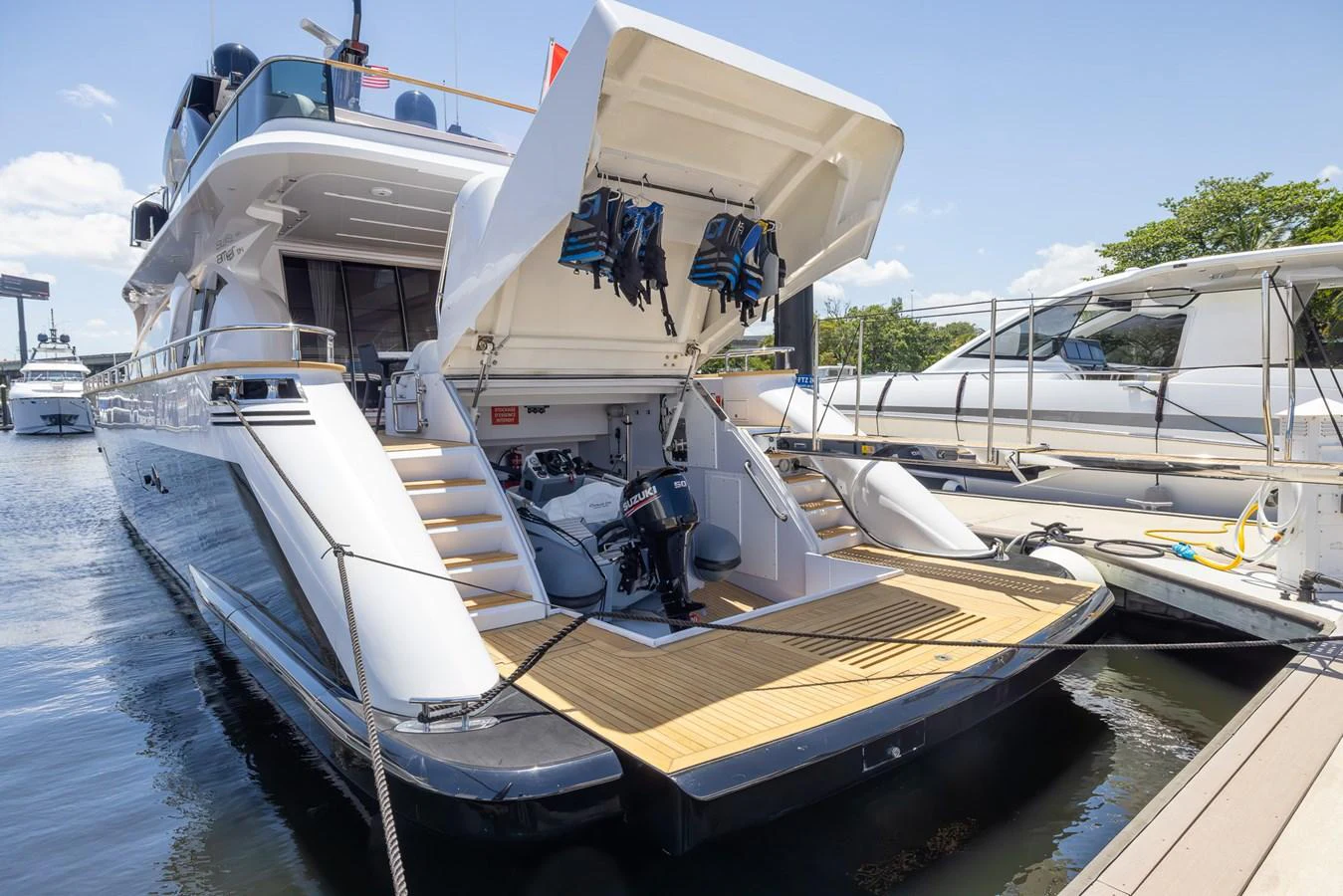 The yacht is docked with its aft deck open, revealing storage space and equipment. aboard SEA METRI V Yacht for Sale