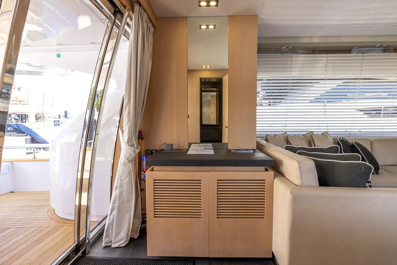 A stylish interior space featuring a mix of wood and neutral tones with comfortable seating and modern design. aboard SEA METRI V Yacht for Sale