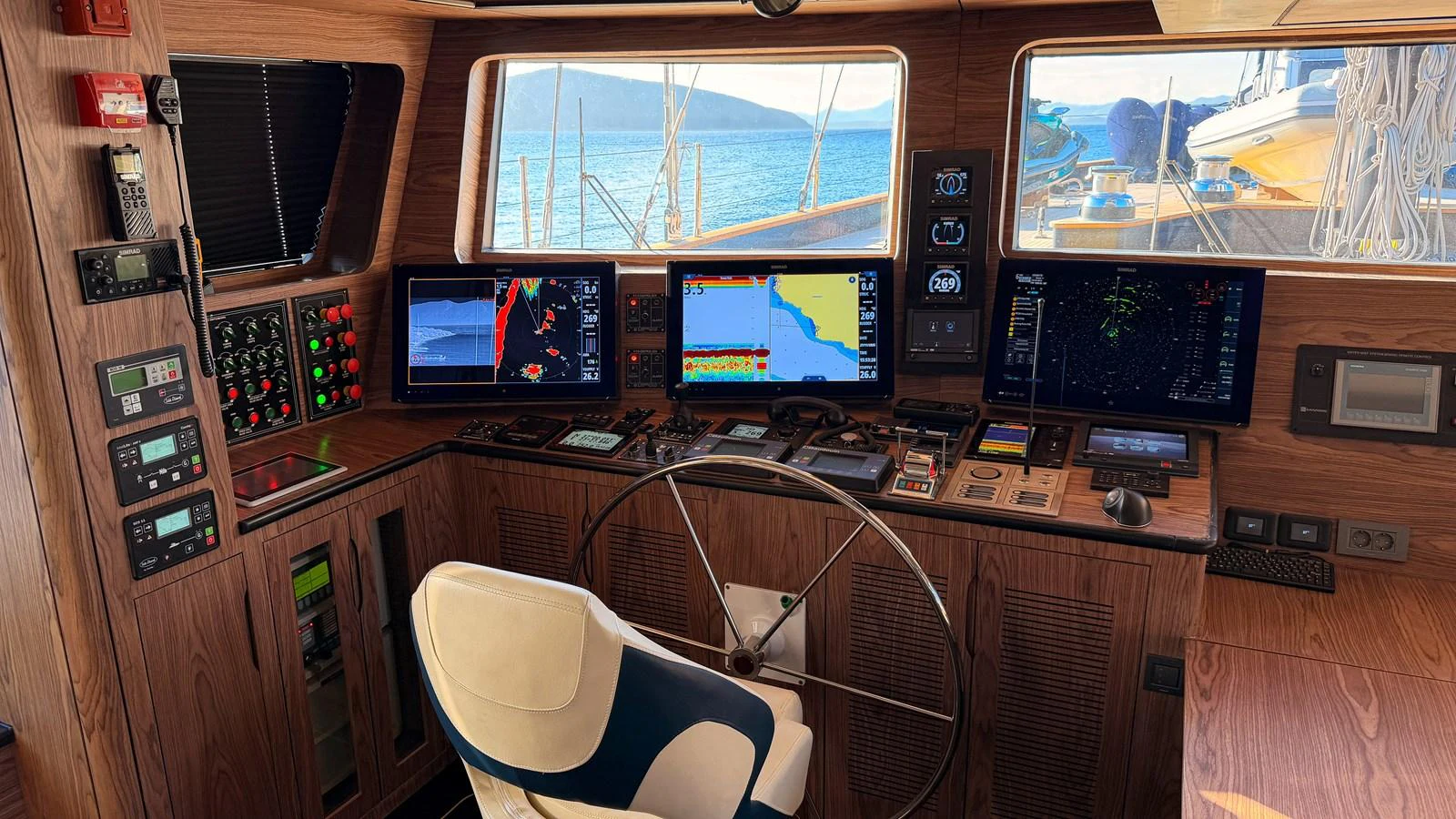 The yacht's helm features advanced navigation equipment and a comfortable captain's chair, offering a commanding view of the sea. aboard OGUZ KHAN Yacht for Sale