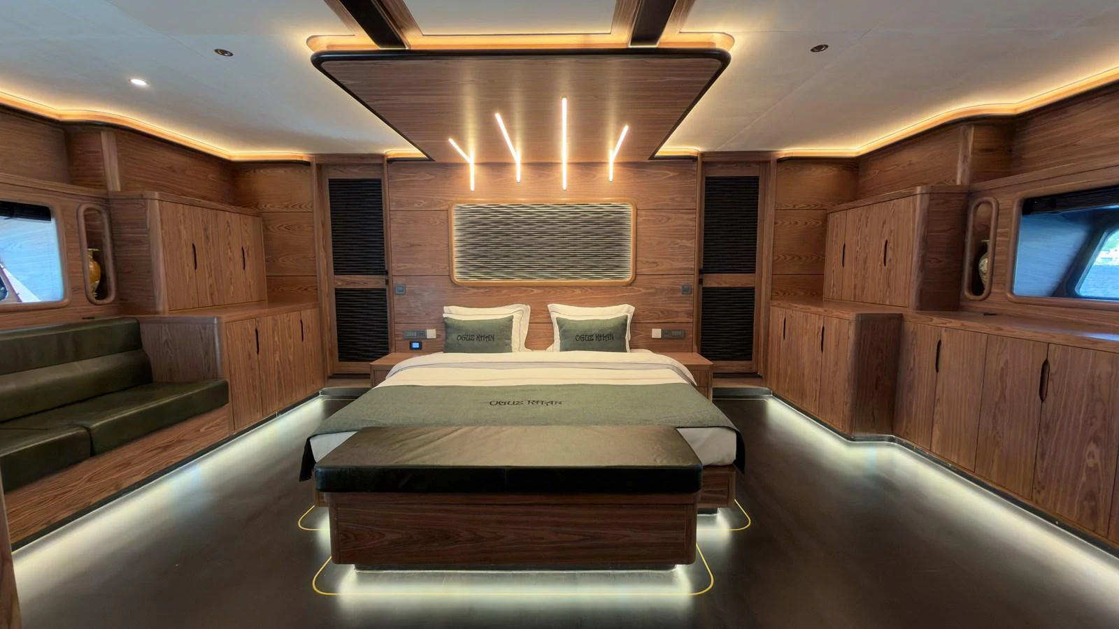 The master stateroom features luxurious wood paneling and modern lighting for an elegant and cozy atmosphere. aboard OGUZ KHAN Yacht for Sale