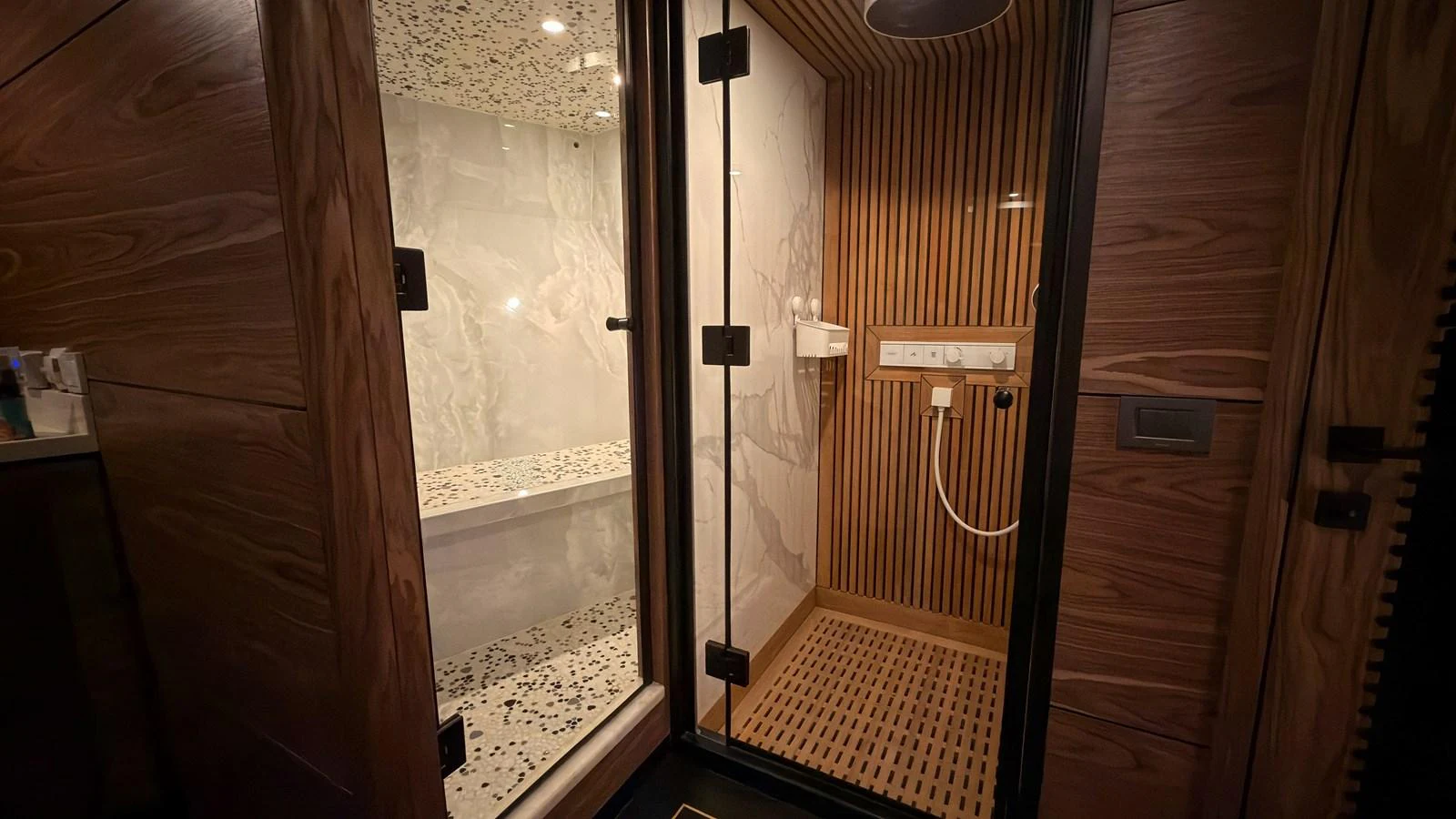 A luxurious yacht bathroom featuring a modern shower and wooden accents. aboard OGUZ KHAN Yacht for Sale