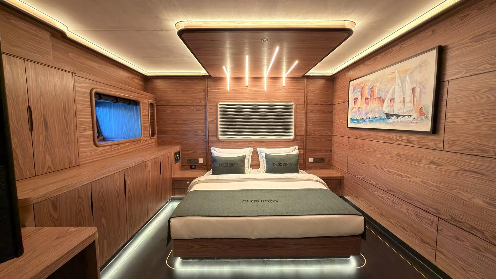 The stateroom features elegant wood paneling, ambient lighting, and a comfortable bed with luxurious linens. aboard OGUZ KHAN Yacht for Sale