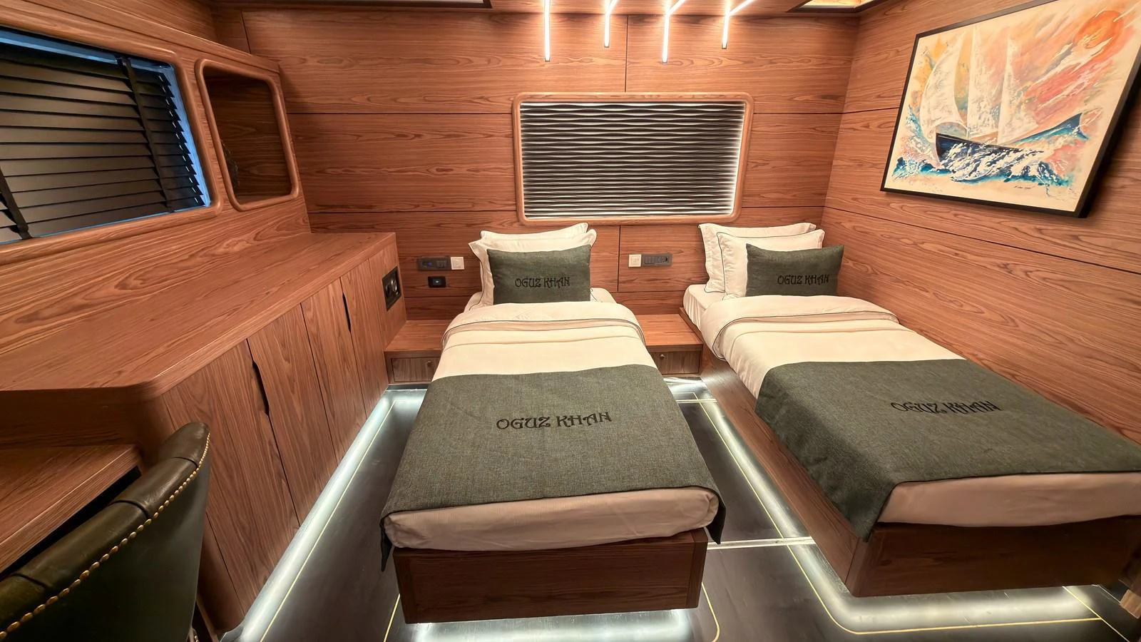 A cozy twin stateroom with modern wooden finishes and ambient lighting. aboard OGUZ KHAN Yacht for Sale