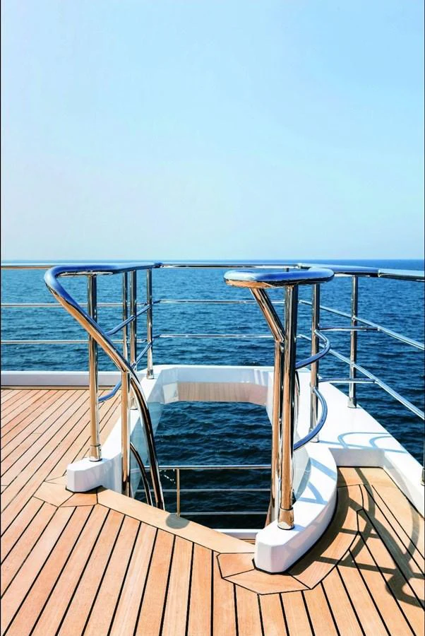 a deck with a chair and a table on it aboard SHABBY OF THE SEAS Yacht for Sale