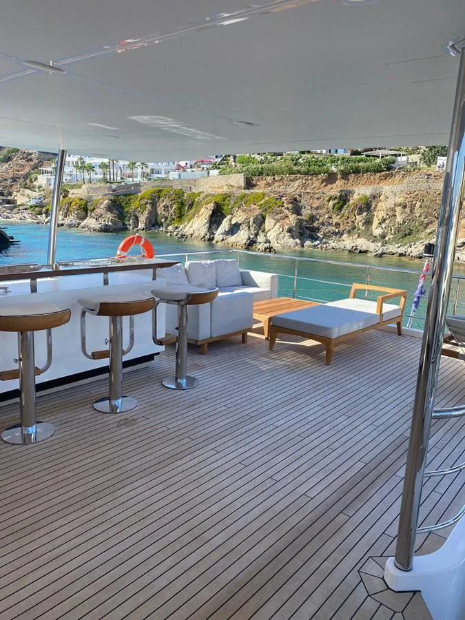 a deck with tables and chairs aboard SHABBY OF THE SEAS Yacht for Sale