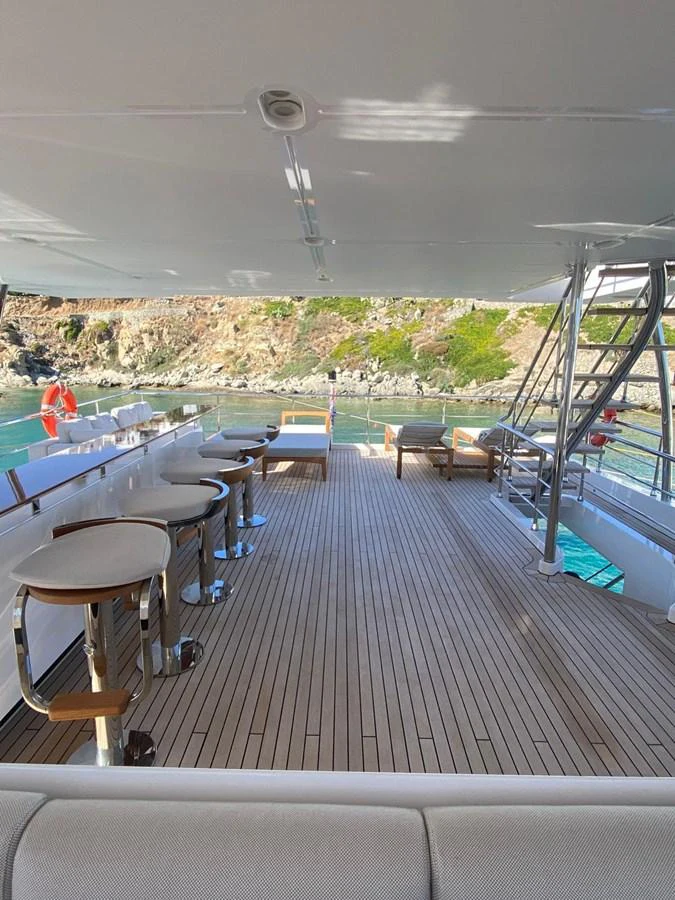 a deck with a pool and a view of a field aboard SHABBY OF THE SEAS Yacht for Sale