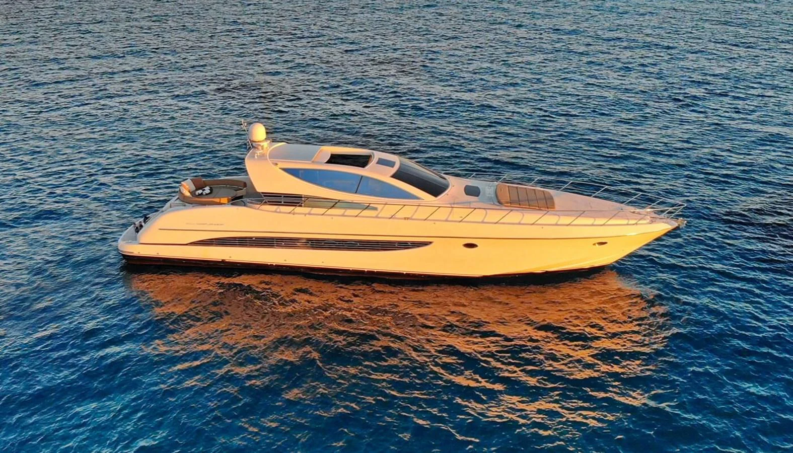 A sleek and modern yacht glides gracefully on calm waters during sunset. aboard RIVA 72' Yacht for Sale