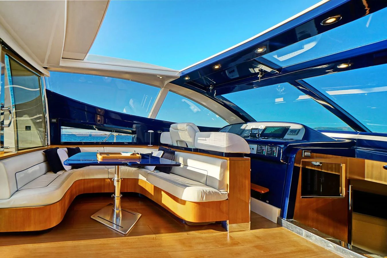 The yacht's helm area features a sleek and modern design with ample seating and panoramic views. aboard RIVA 72' Yacht for Sale