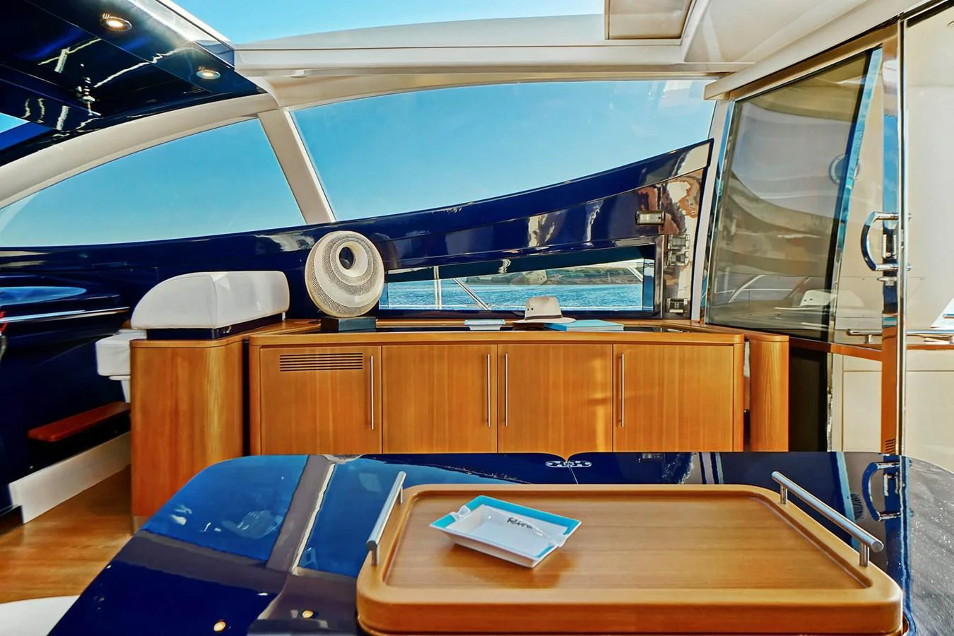 The yacht's saloon features sleek wooden cabinetry and expansive windows for a bright, open feel. aboard RIVA 72' Yacht for Sale