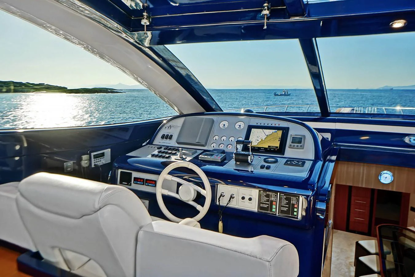 The helm station offers a commanding view with state-of-the-art navigation equipment and luxurious seating. aboard RIVA 72' Yacht for Sale