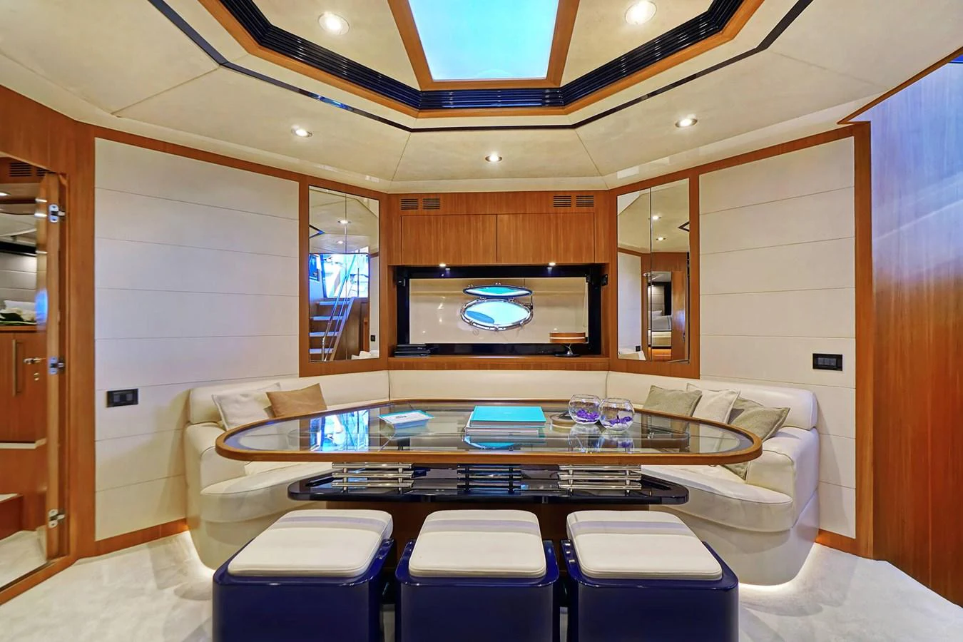 The yacht's dining area features a sleek table surrounded by comfortable seating, creating an inviting space for meals. aboard RIVA 72' Yacht for Sale