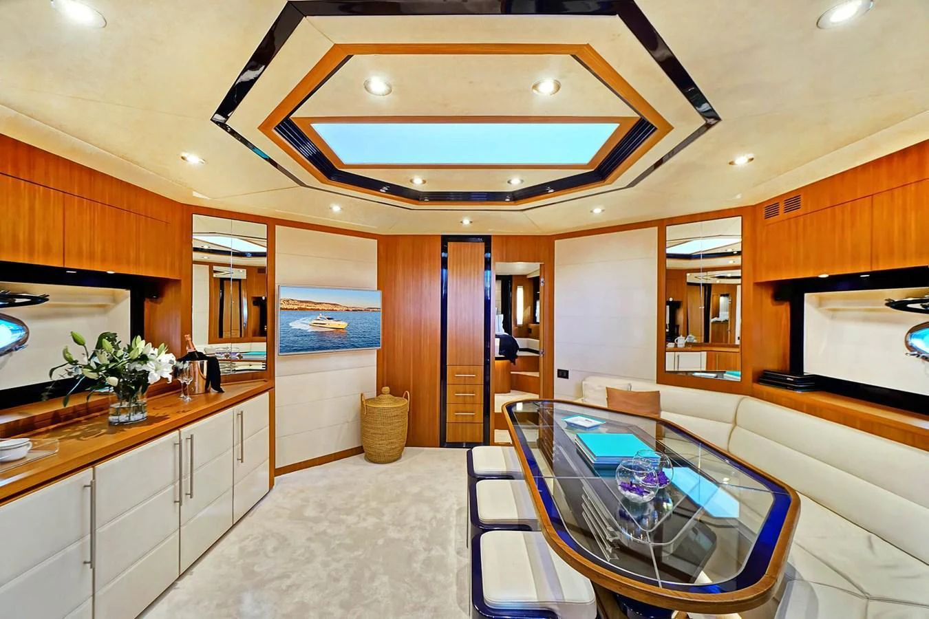 The yacht's dining area features a modern design with elegant wood finishes and ample natural light. aboard RIVA 72' Yacht for Sale