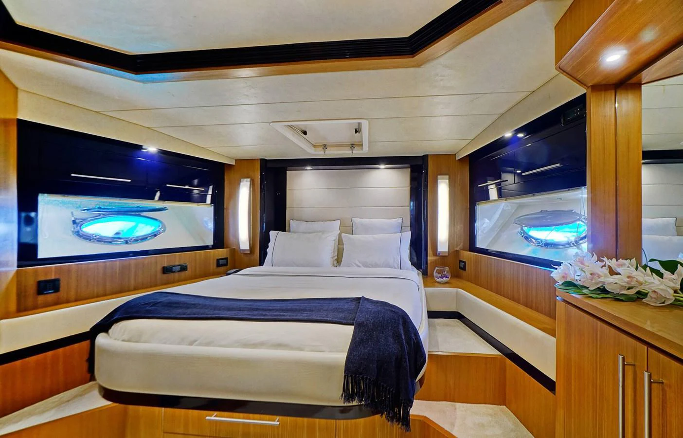 The stateroom features a comfortable bed with elegant lighting and wood finishes. aboard RIVA 72' Yacht for Sale