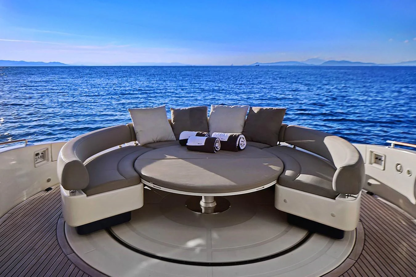 The aft deck features a luxurious circular seating area with panoramic ocean views. aboard RIVA 72' Yacht for Sale