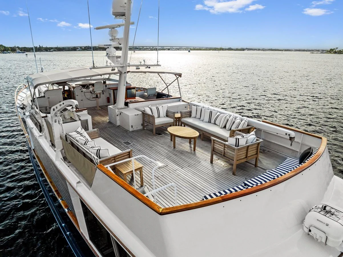 The yacht's aft deck features a spacious seating area with elegant furnishings, perfect for relaxation and socializing. aboard CHANTICLEER Yacht for Sale