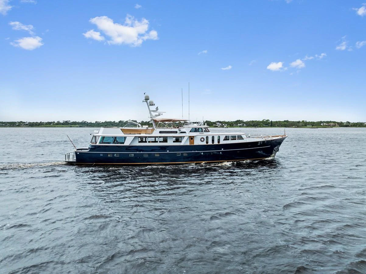A classic yacht cruising on calm waters under a clear blue sky. aboard CHANTICLEER Yacht for Sale