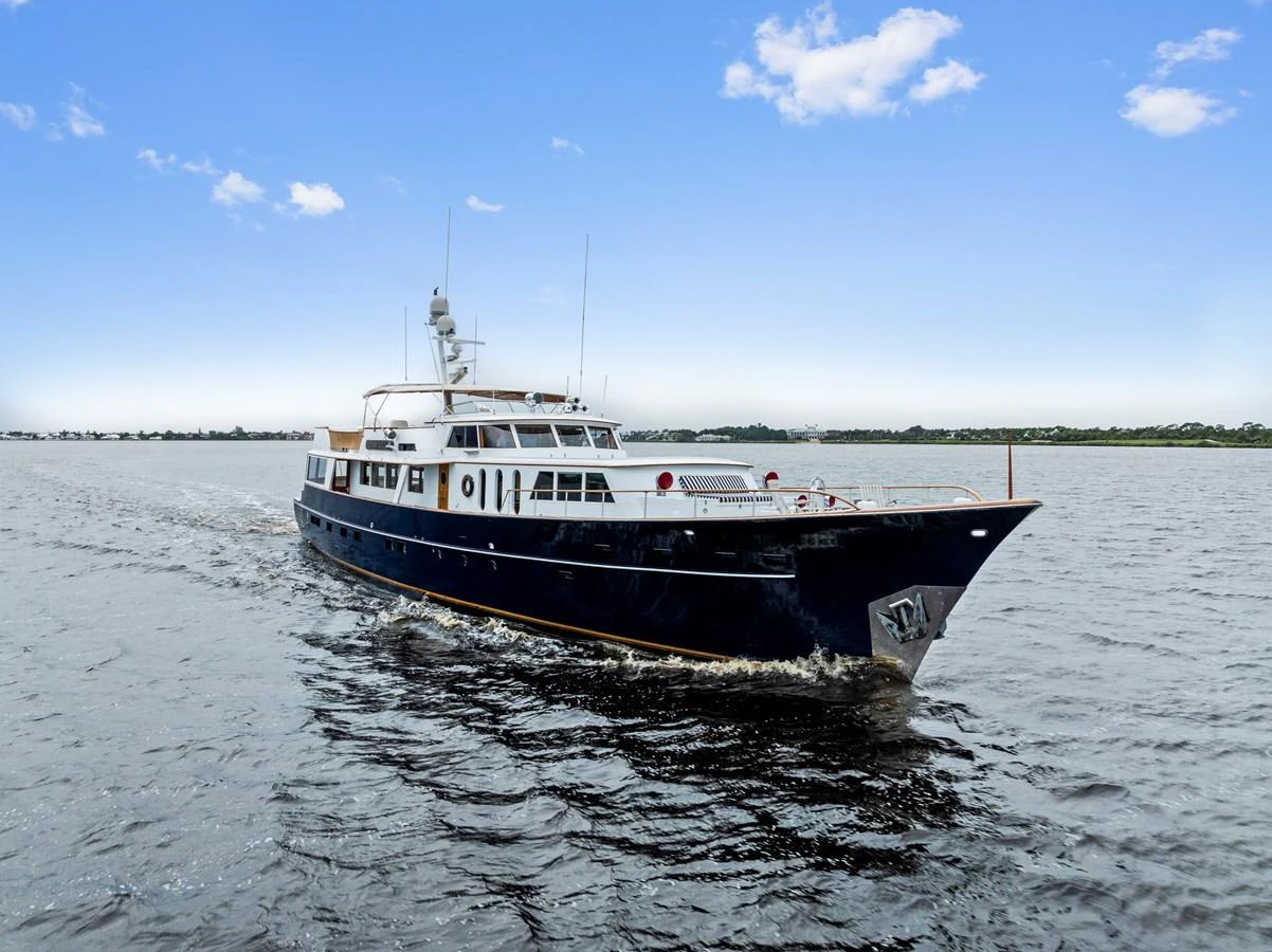 A classic yacht glides smoothly over calm waters under a clear blue sky. aboard CHANTICLEER Yacht for Sale