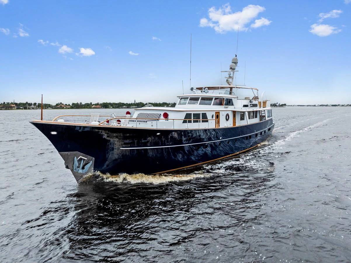 A classic yacht cruises gracefully on calm waters under a clear blue sky. aboard CHANTICLEER Yacht for Sale