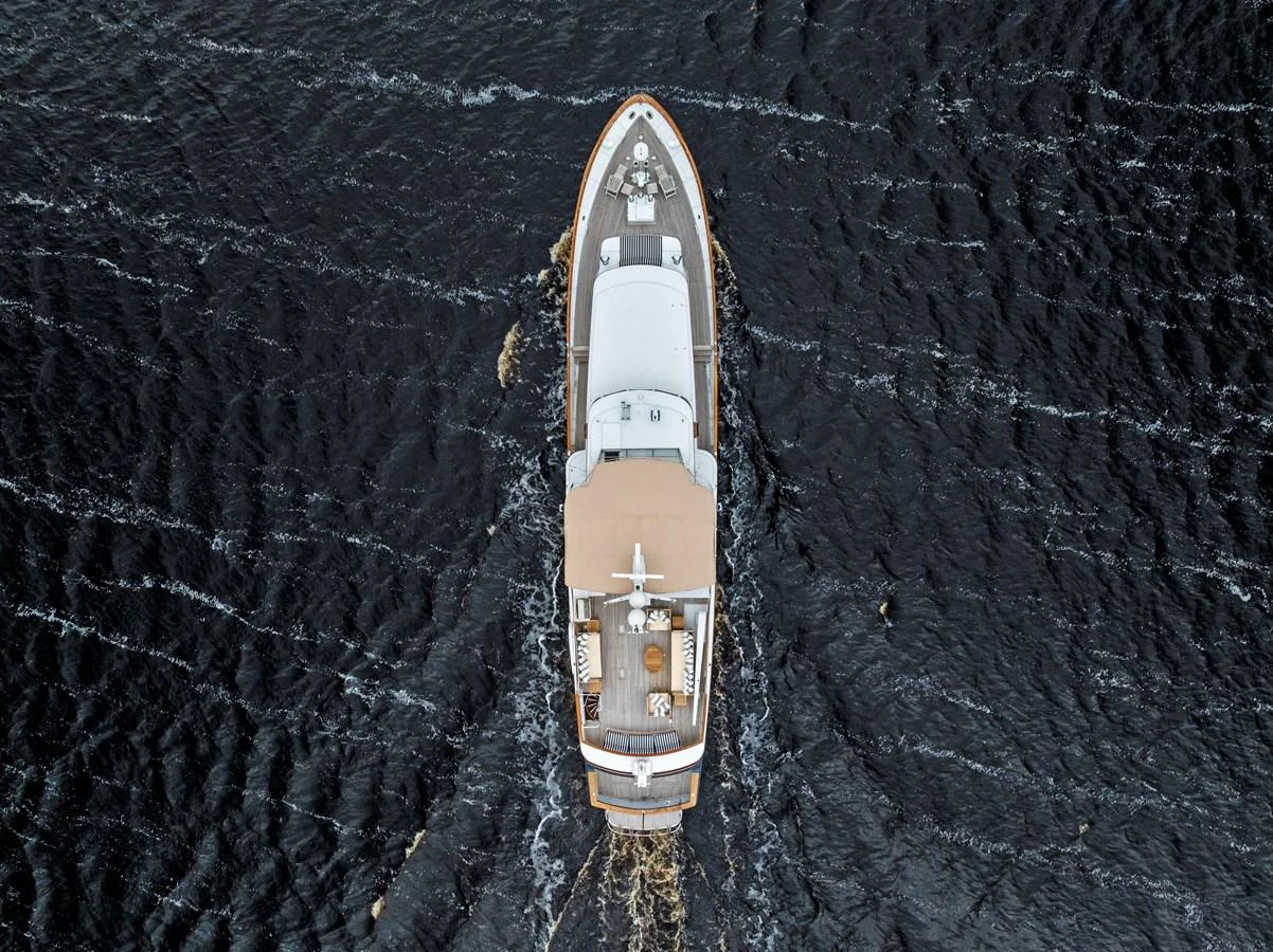 Aerial view of a luxurious yacht cruising through dark waters. aboard CHANTICLEER Yacht for Sale