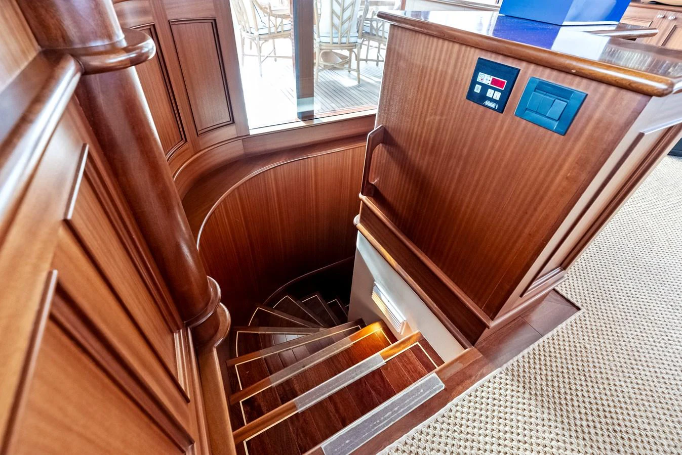 A beautifully crafted wooden staircase leads to the lower deck, showcasing the yacht's elegant interior design. aboard CHANTICLEER Yacht for Sale