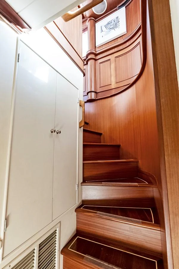A beautifully crafted wooden staircase leads to the upper deck of the yacht. aboard CHANTICLEER Yacht for Sale