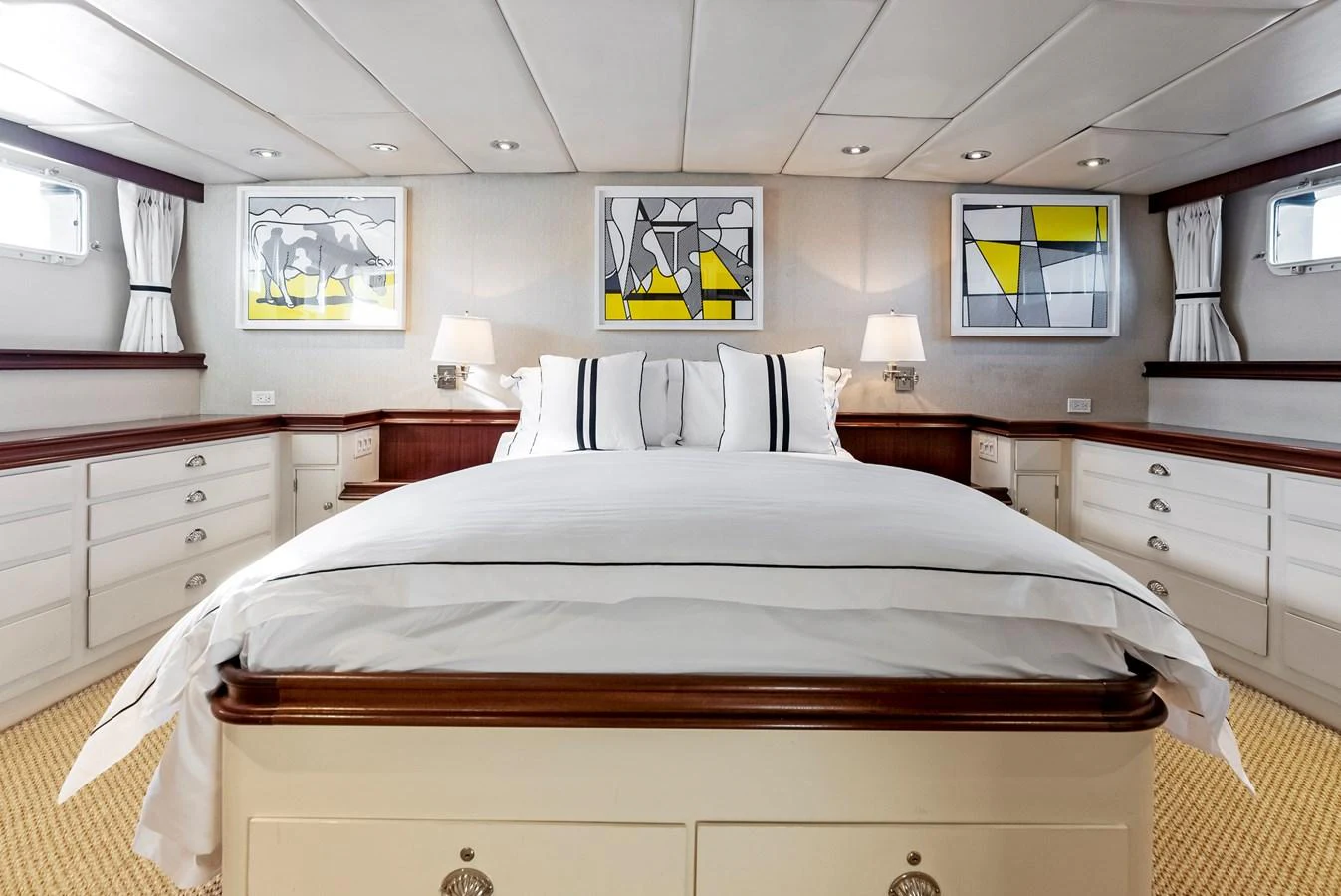 The master stateroom features a luxurious bed with elegant bedding and modern art on the walls. aboard CHANTICLEER Yacht for Sale